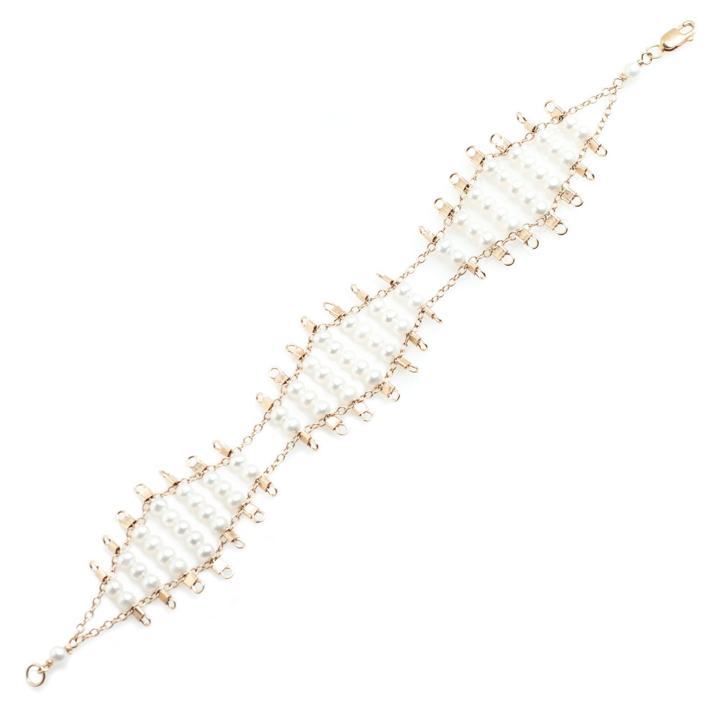 Kellan bracelet, featuring undulating rows of lustrous, white pearls, suspended on rows of 14k gold-fill wire and chain, and finished with a lobster clasp. Approximately 7 inches in length.