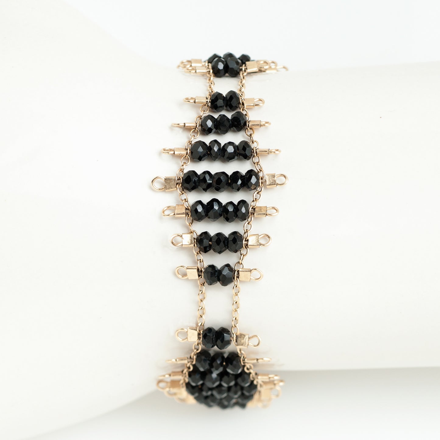 Kellan bracelet featuring rows of faceted Onyx beads, suspended on rows of 14k gold-fill wire and chain, and finished with a lobster clasp.