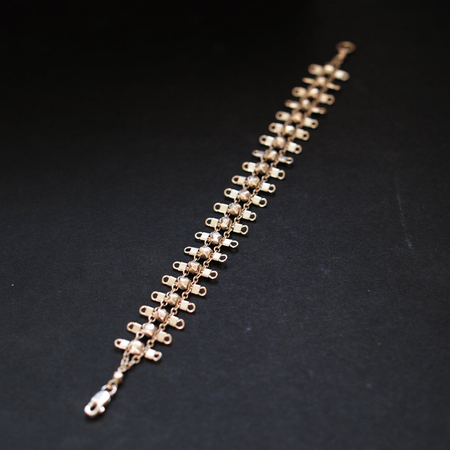 Artemis bracelet, featuring faceted, sterling silver beads suspended on sterling rungs and chain, finished with a lobster clasp. Approximately 7 inches in length.