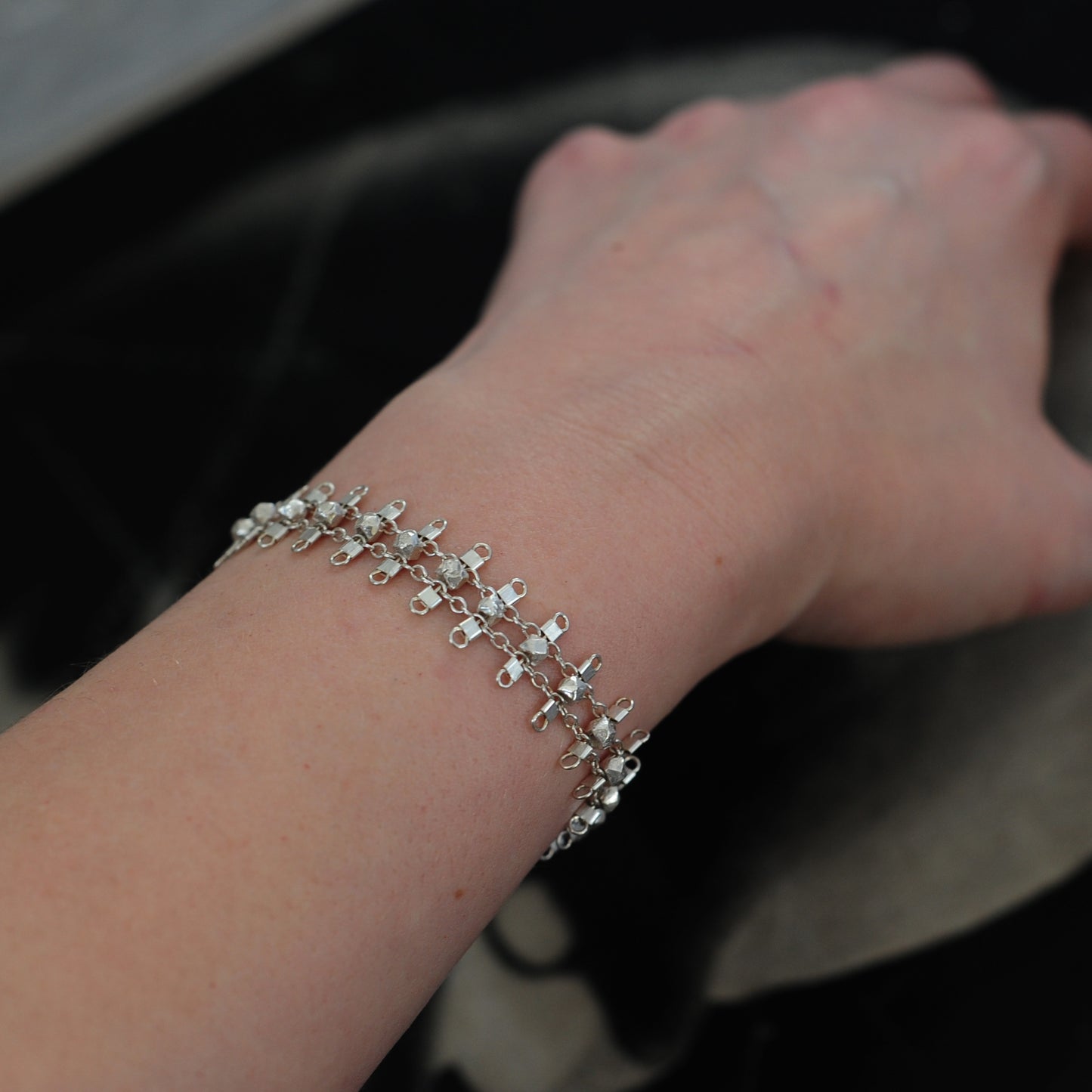 Artemis bracelet, featuring faceted, sterling silver beads suspended on sterling rungs and chain, finished with a lobster clasp. Approximately 7 inches in length.
